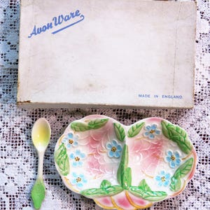 May include: A vintage Avon Ware serving dish and spoon set. The dish is divided, featuring pink, blue, and green floral patterns. The box displays "Avon Ware" and "Made in England."