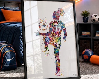 May include: Framed watercolor print of a soccer player in action, with the name "Beckie" and the number "17" on the jersey. The artwork features a vibrant, colorful splatter effect. A soccer ball is in the air near the player's foot.