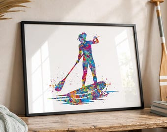 Könnte beinhalten: Gerahmter Aquarelldruck einer Person beim Stand-Up-Paddling. Das Kunstwerk zeigt eine farbenfrohe Silhouette einer Person auf einem Brett mit einem Paddel vor weißem Hintergrund. Das Bild ist in einem schwarzen Rahmen.