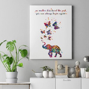 May include: A colorful watercolor painting of an elephant with butterflies flying around it. The quote "no matter how hard the past, you can always begin again." is written in the top left corner of the painting.