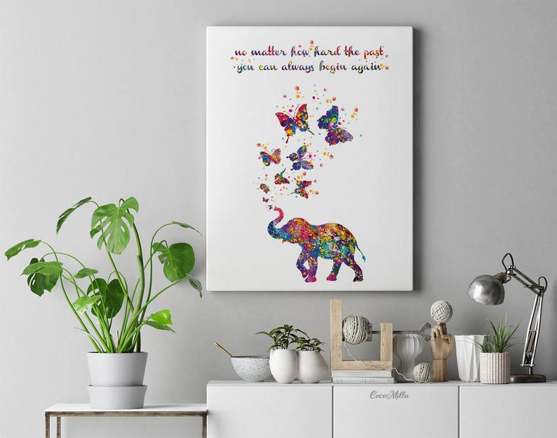 May include: A colorful watercolor painting of an elephant with butterflies flying around it. The quote "no matter how hard the past, you can always begin again." is written in the top left corner of the painting.