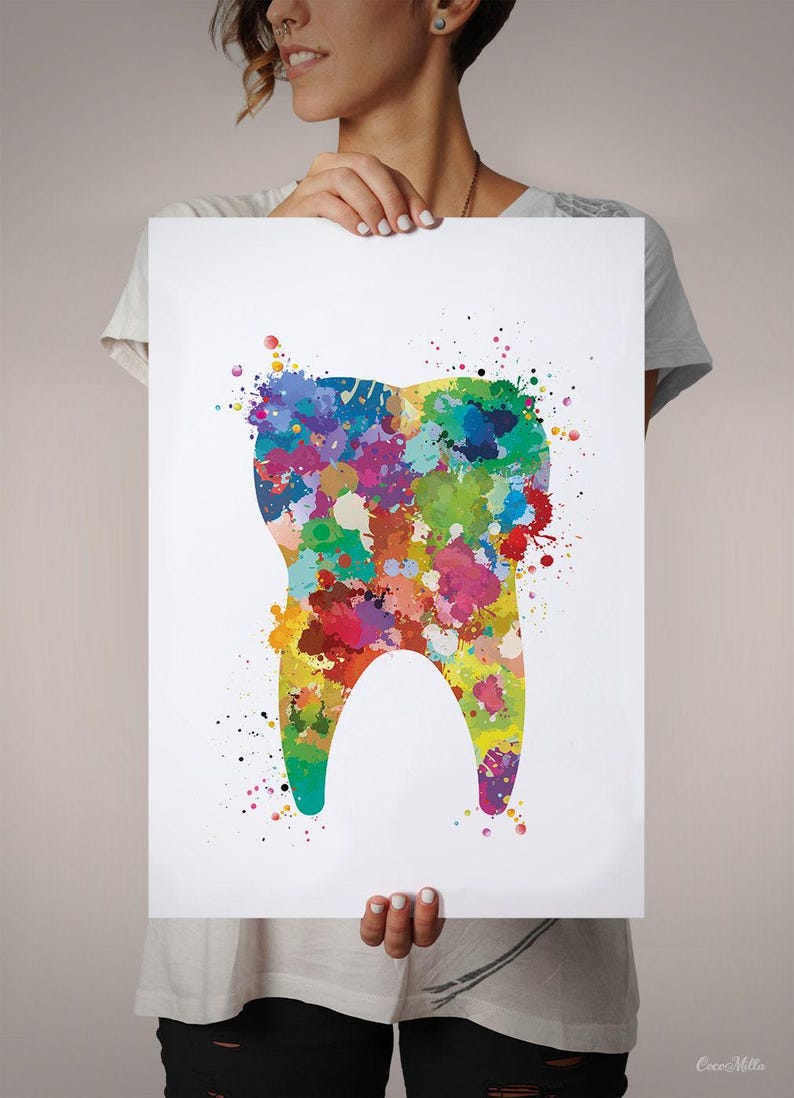 May include: A colorful watercolor print of a tooth. The tooth is filled with vibrant paint splatters in shades of red, yellow, green, blue, and purple. The artwork is held by a person.