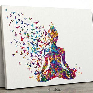 May include: A canvas print features a person in a yoga pose, rendered in a watercolour style. The figure is made up of colourful paint splatters, with a flock of birds flying from the head. The birds are in shades of blue, purple, red, and yellow.