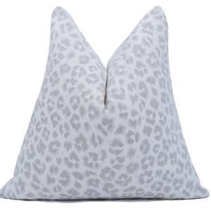 May include: A white pillow with a gray leopard print pattern.