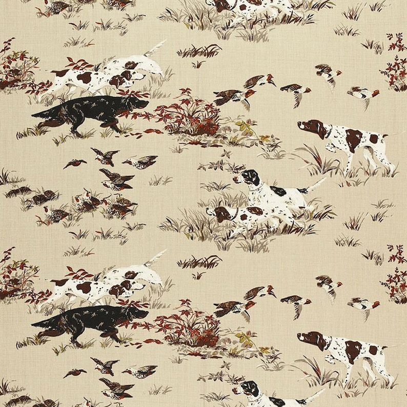 May include: A beige fabric with a repeating pattern of black and white dogs, brown and white dogs, and brown birds in flight. The dogs are running and the birds are flying in a variety of directions.