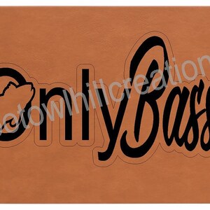 May include: A brown rectangular item with the words "Only Bass" in black script and a fish graphic. The item has a leather-like texture and a light brown color.