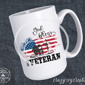 May include: White ceramic mug featuring an American flag design with the words "God Bless the Veteran." The design includes a silhouette of a soldier and the text "Crazy SVG Creations" at the bottom.