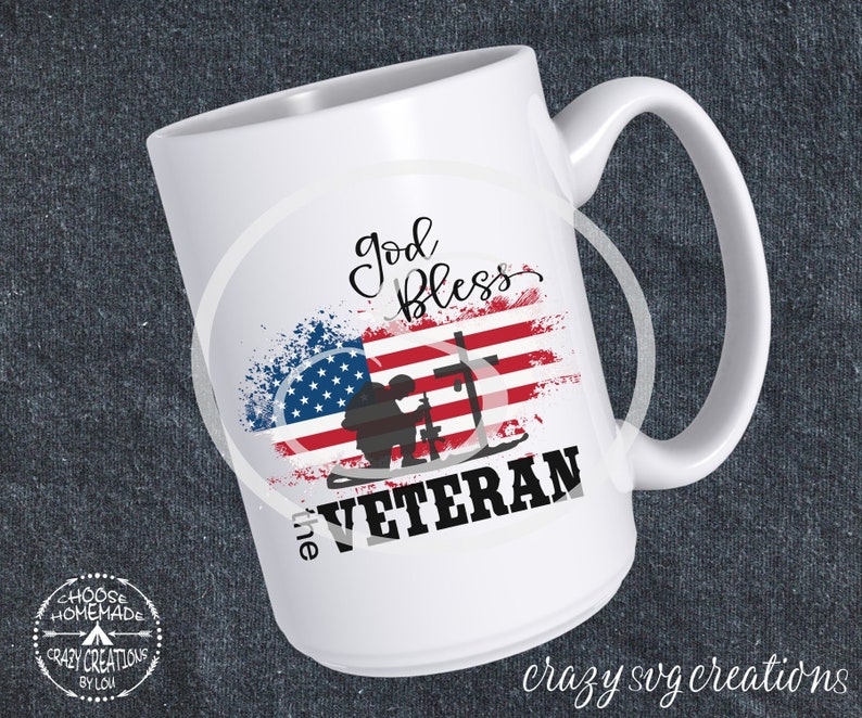May include: White ceramic mug featuring an American flag design with the words "God Bless the Veteran." The design includes a silhouette of a soldier and the text "Crazy SVG Creations" at the bottom.