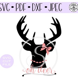 May include: A black silhouette of a deer head with large antlers. The deer is wearing a pink bow and a black beaded necklace. The text "oh deer" is written in cursive below the deer.