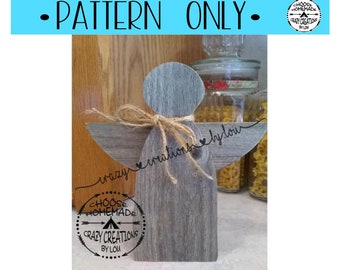 May include: A wood cutout of an angel with wings, a bow, and the text "crazy creations by lou" on the wings. The angel is painted in a gray wash color. The text "CHOOSE HOMEMADE CRAZY CREATIONS BY LOU" is in a circle with arrows on the bottom of the angel.