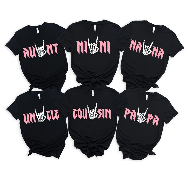 May include: Six black t-shirts with white text and pink rock and roll hand symbols. The shirts say "Aunt", "Nini", "Nana", "Uncle", "Cousin", and "Papa".