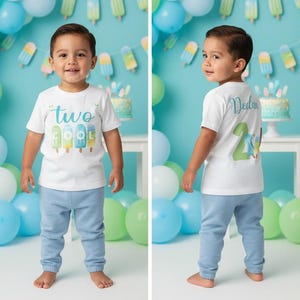 May include: A two-panel image shows a young child wearing a white t-shirt and light blue pants. The shirt says "two cool" with popsicle graphics. The back of the shirt has the number "2" and the name "Dedan". Balloons and a cake are in the background.