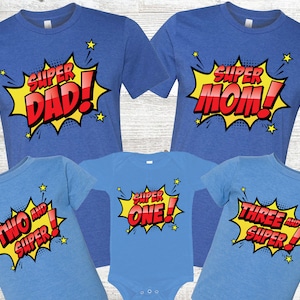 Superbohaterowie, chłopcy na urodzinach na niebieskich koszulkach - super tata, super mama, 1. urodziny, 2. urodziny, 3. urodziny, superbohaterowie z komiksów, komiksowe plamy