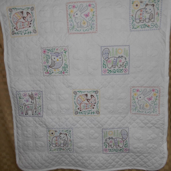 Woodland Charm Vintage-inspired Quilt. Machine embroidered child's quilt of various woodland animals. Backed with coordinating flannel print