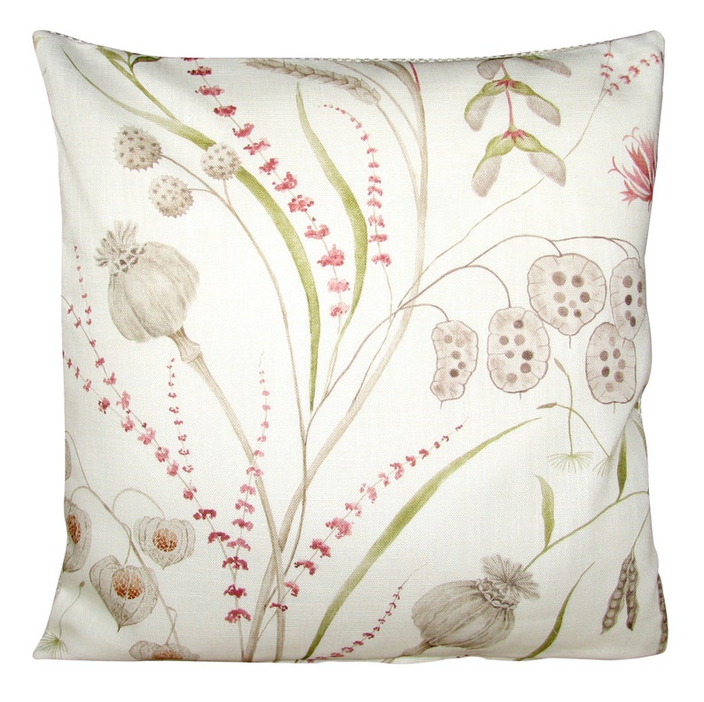 May include: A square throw pillow featuring an off-white fabric base with a botanical print. The design displays various dried seed pods, grasses, and slender stems in muted shades of sage green, soft pink, and light brown across the surface.