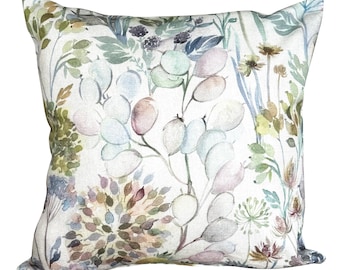 May include: Square cushion with a watercolour floral design. The cushion features a white background with a pattern of green, blue, and pink leaves and flowers. A decorative home accent.