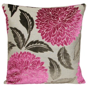 May include: A square cushion with a beige linen background and a pink and brown floral pattern. The flowers are large and have a velvety texture.