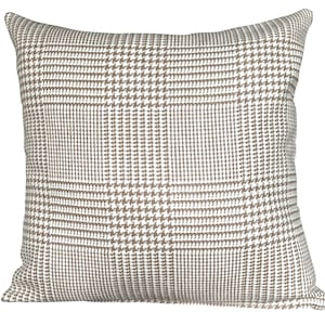 May include: Square cushion featuring a brown and white houndstooth design. The cushion has a textured surface and is intended for decorative purposes on a sofa or bed. The neutral colour scheme allows it to blend with different interior decor styles.