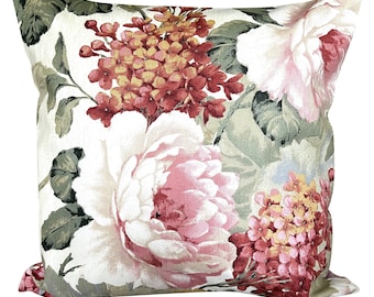 May include: A square cushion with a floral pattern featuring pink, red, and yellow flowers on a cream background.