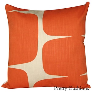 May include: Orange and cream colored throw pillow with a geometric pattern. The pillow is made of a soft, textured fabric.