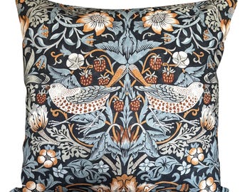 May include: Square throw pillow with a detailed floral and bird pattern. The design features birds, strawberries, and flowers in shades of black, blue, orange, and white. The pillow has a soft, textured appearance.