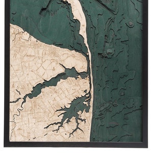 May include: A wooden map of the Long Island Sound, New York, with a teal blue color scheme. The map shows the coastline, rivers, and towns. The map is framed in black.