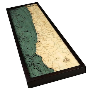 May include: A rectangular wooden wall map featuring a 3D bathymetric design of a coastline. The land portion is light tan wood with engraved details, while the water is layered in shades of teal. A compass rose is engraved in the lower right corner.