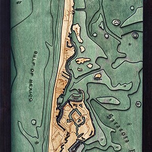 May include: A wooden map of Longboat Key, Florida, with a compass rose and the text "Longboat Key, Florida". The map is carved in a light wood and painted in shades of green and brown. The map shows the coastline, waterways, and islands of Longboat Key.