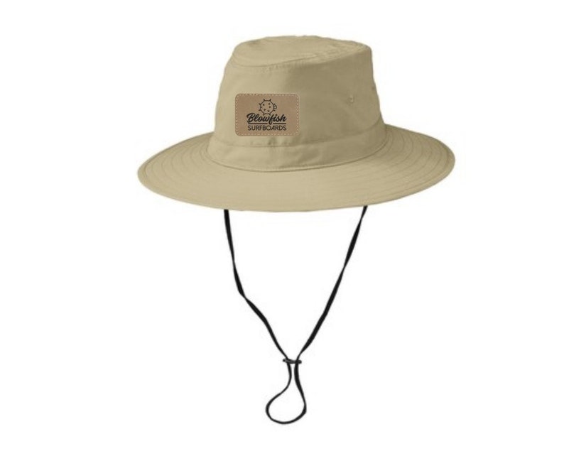 May include: A beige sun hat with a black chin strap and a brown patch with the text "Blowfish Surfboards".