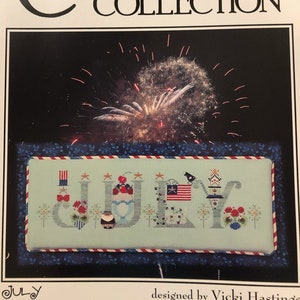 May include: Cross stitch pattern for a July themed design featuring the word "JULY" with patriotic imagery. The pattern is from The Cricket Collection, No. 326, designed by Vicki Hastings.