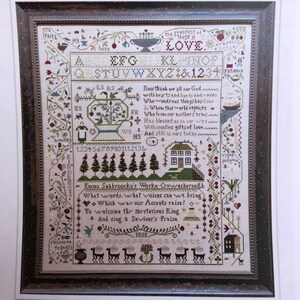 May include: Framed cross-stitch sampler titled "A Saviour's Praise" with floral and geometric designs, text, and a house illustration. The design includes the text "an original design", the alphabet, numbers, and the year 1838.