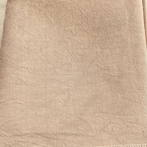 May include: A close-up of a beige linen fabric with a woven texture. The fabric is smooth and has a subtle sheen.