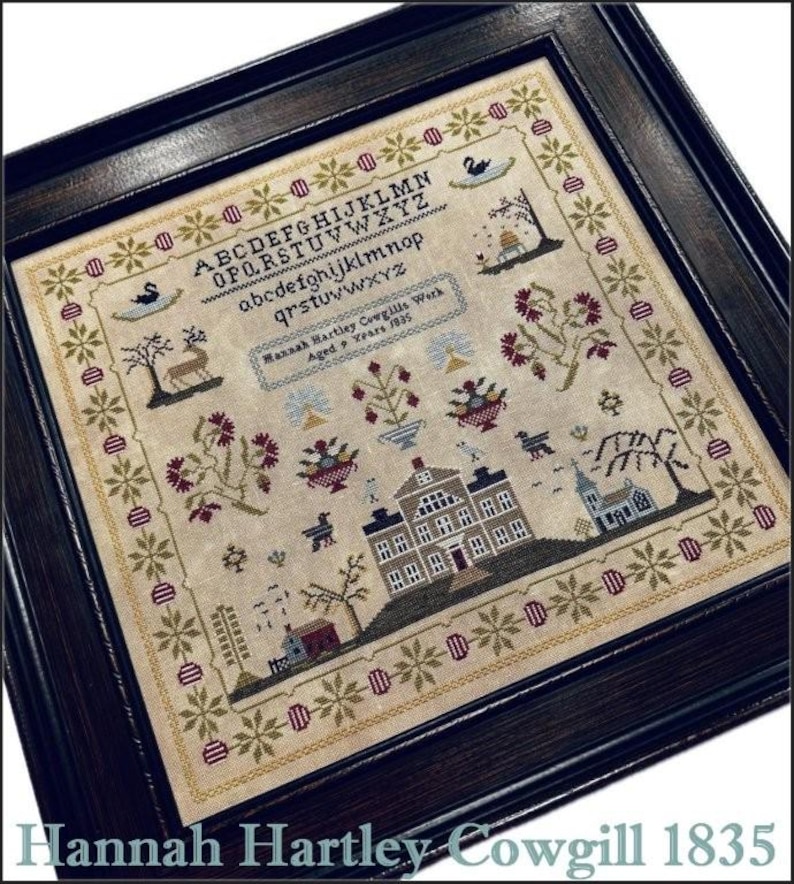 May include: A framed sampler with a beige background and a colourful cross-stitch design. The design includes a house, flowers, birds, and a tree. The sampler is titled "Hannah Hartley Cowgill's Work Aged 9 Years 1835".