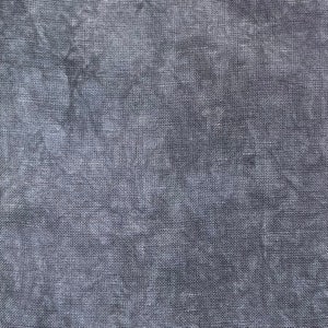 May include: Close-up of a textured, dark gray fabric. The material has a woven appearance with subtle variations in tone, creating a mottled effect. The fabric appears to be linen or a similar natural fiber, suitable for clothing or home decor.