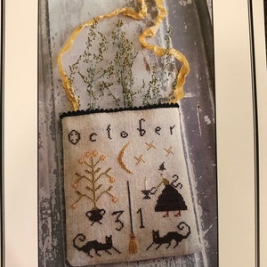 May include: Cross stitch pattern for a Halloween-themed tote bag with a witch, cat, broom, and the text "October 31st".