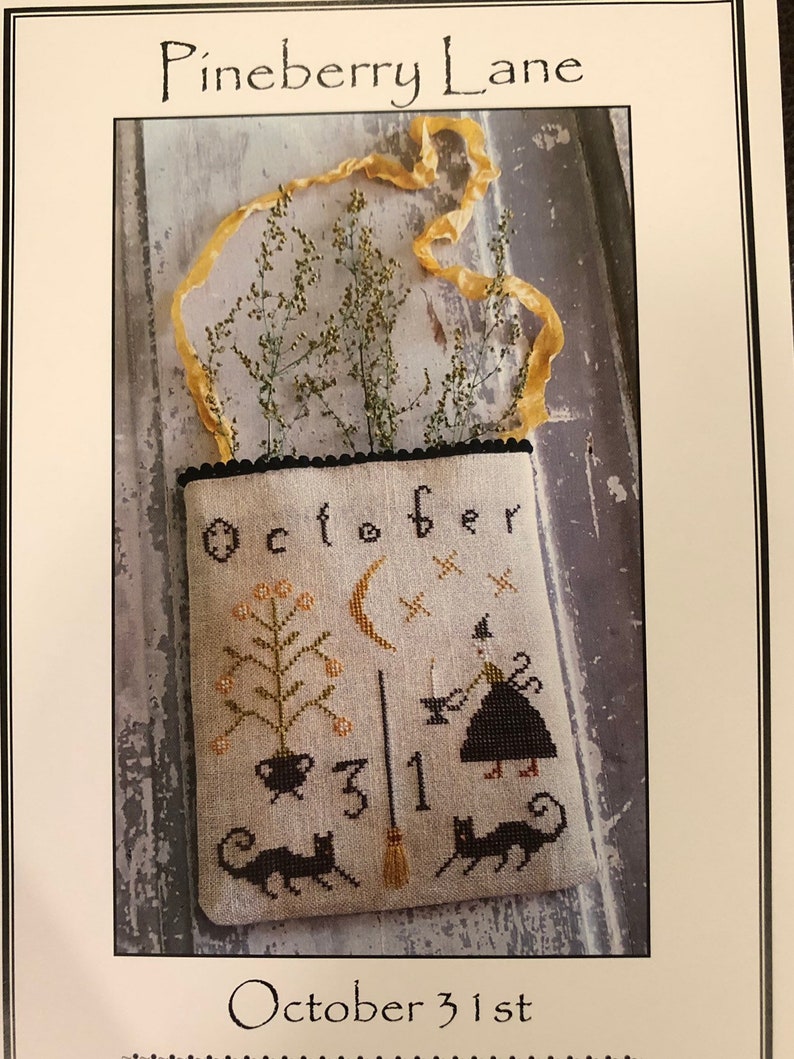 May include: Cross stitch pattern for a Halloween-themed tote bag with a witch, cat, broom, and the text "October 31st".