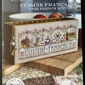 May include: A cross-stitch pattern for a kitchen-themed design featuring a basket of fruit and the text "Cuisine Française" in French. The pattern is from Summer House Stitch Works and is part of the "The French Kitchen" collection.
