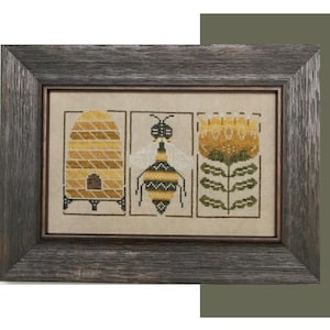 May include: A framed cross-stitch design featuring a bee, a honeycomb, and a flower. The bee is yellow and black with a striped body. The honeycomb is brown and yellow with a small opening. The flower is yellow with green leaves.