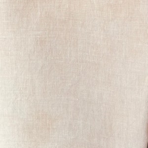 May include: Close-up of a beige linen fabric. The fabric has a woven texture, with visible threads creating a grid-like pattern. The colour is a neutral, light beige, suitable for various textile applications.
