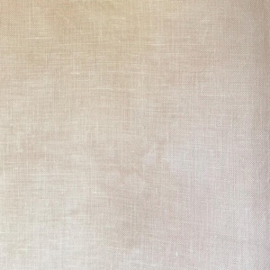 May include: A close-up view of a light beige fabric with a visible woven texture. The material features a consistent grid-like pattern created by the interlacing of horizontal and vertical threads, resulting in a natural, matte, and neutral appearance.