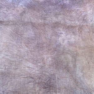 May include: A piece of fabric with a mottled, textured appearance in shades of purple and brown. The words "Halloween Evening" are printed at the top. The fabric has a subtle, faded look, suggesting a vintage or handcrafted quality.