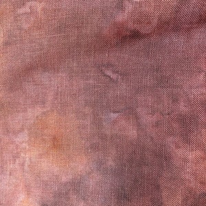 May include: Close-up of a brown fabric with a woven texture. The fabric has a slightly faded appearance, with a subtle variation in color.
