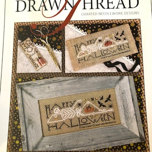 May include: A cross stitch pattern for a Halloween-themed design featuring a skeleton with the text "Happy Halloween". The pattern is framed in a rustic wooden frame and is on a white background with black and gold polka dots.