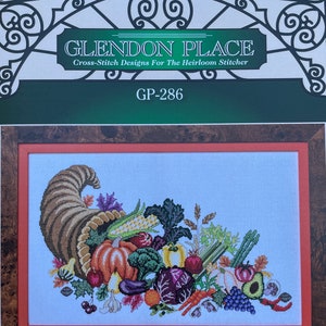 May include: Cross-stitch pattern for a cornucopia overflowing with autumn vegetables and fruits, including corn, pumpkins, grapes, and eggplant. The pattern is titled "Horn of Plenty" and is from Glendon Place Cross-Stitch Designs for the Heirloom Stitcher. The pattern number is GP-286.