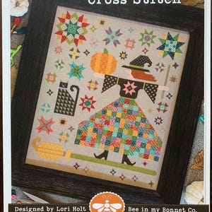 May include: Cross stitch pattern featuring a witch with a pumpkin and a broom, surrounded by stars and a black cat. The pattern is titled "The Quilted Witch Cross Stitch" and is designed by Lori Holt for Bee in my Bonnet Co.