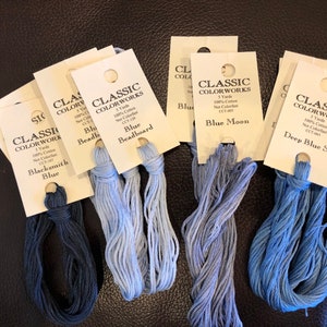 May include: Five spools of Classic Colorworks embroidery floss in shades of blue. The colors are Blacksmith Blue, Beadboard Blue, Blue Moon, and Deep Blue Sea.