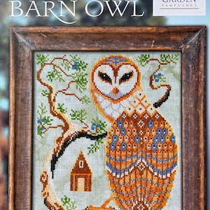 May include: A cross-stitch pattern featuring a barn owl perched on a branch with a small house in the background. The owl is brown, white, and blue with a detailed pattern. The text "A YEAR IN THE WOODS #8 THE BARN OWL" and "COTTAGE GARDEN SAMPLINGS" is visible in the image.