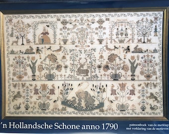 May include: Framed antique sampler with detailed cross-stitch embroidery. The design features figures, animals, and floral motifs, with text and the year 1790. The piece is in a gold frame with a dark blue mat.