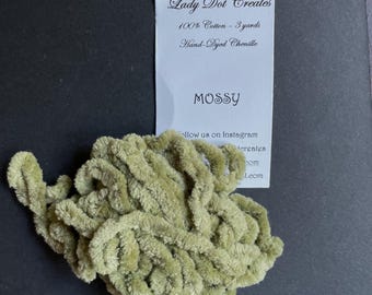 May include: A ball of mossy green chenille yarn, 100% cotton, with a tag that reads "Lady Dot Creates" and "MOSSY". The yarn is hand-dyed and comes in 3 yards.