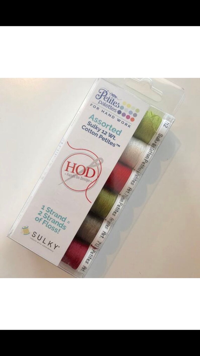 May include: A package of six spools of Sulky Cotton Petites embroidery floss in assorted colors. The package includes the text "Petites palettes" and "Assorted Sulky 12 Wt. Cotton Petites".